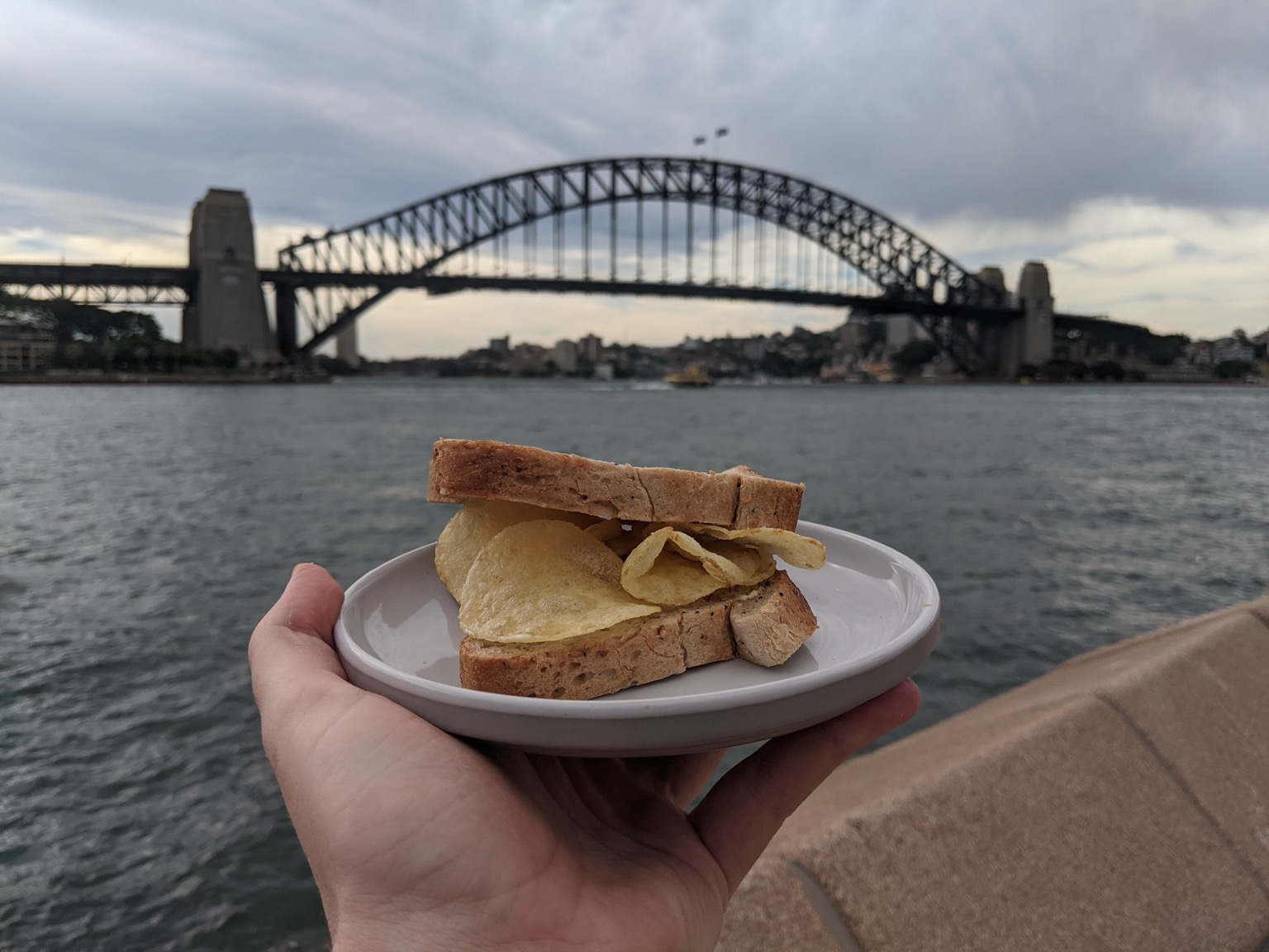 Crisp sandwich held up to Sydney Harbour Bridge