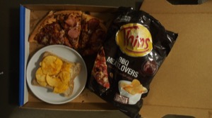 Overhead view of BBQ crisps on bread alongside pizza