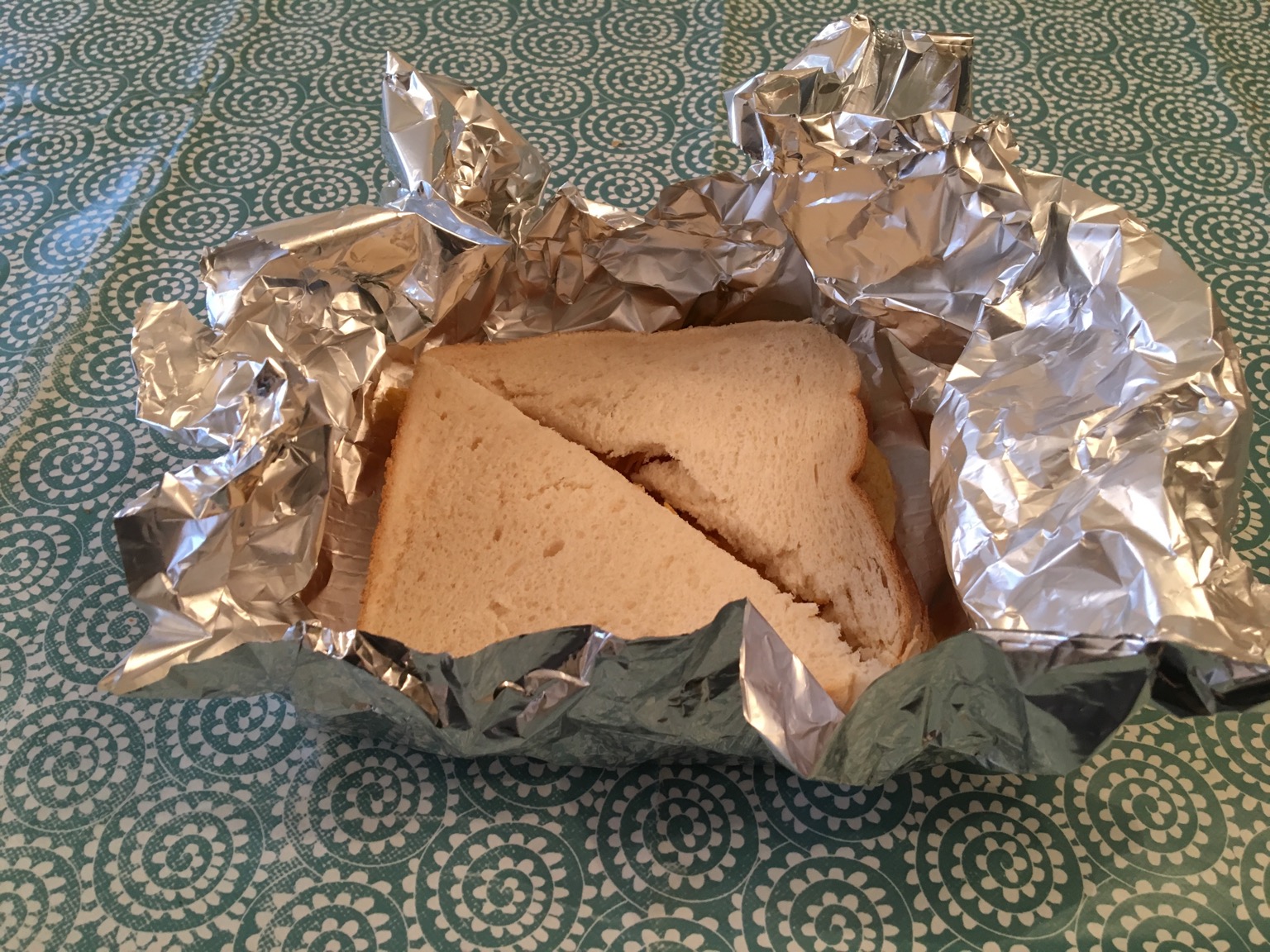 Crisp sandwich in foil, partially unwrapped