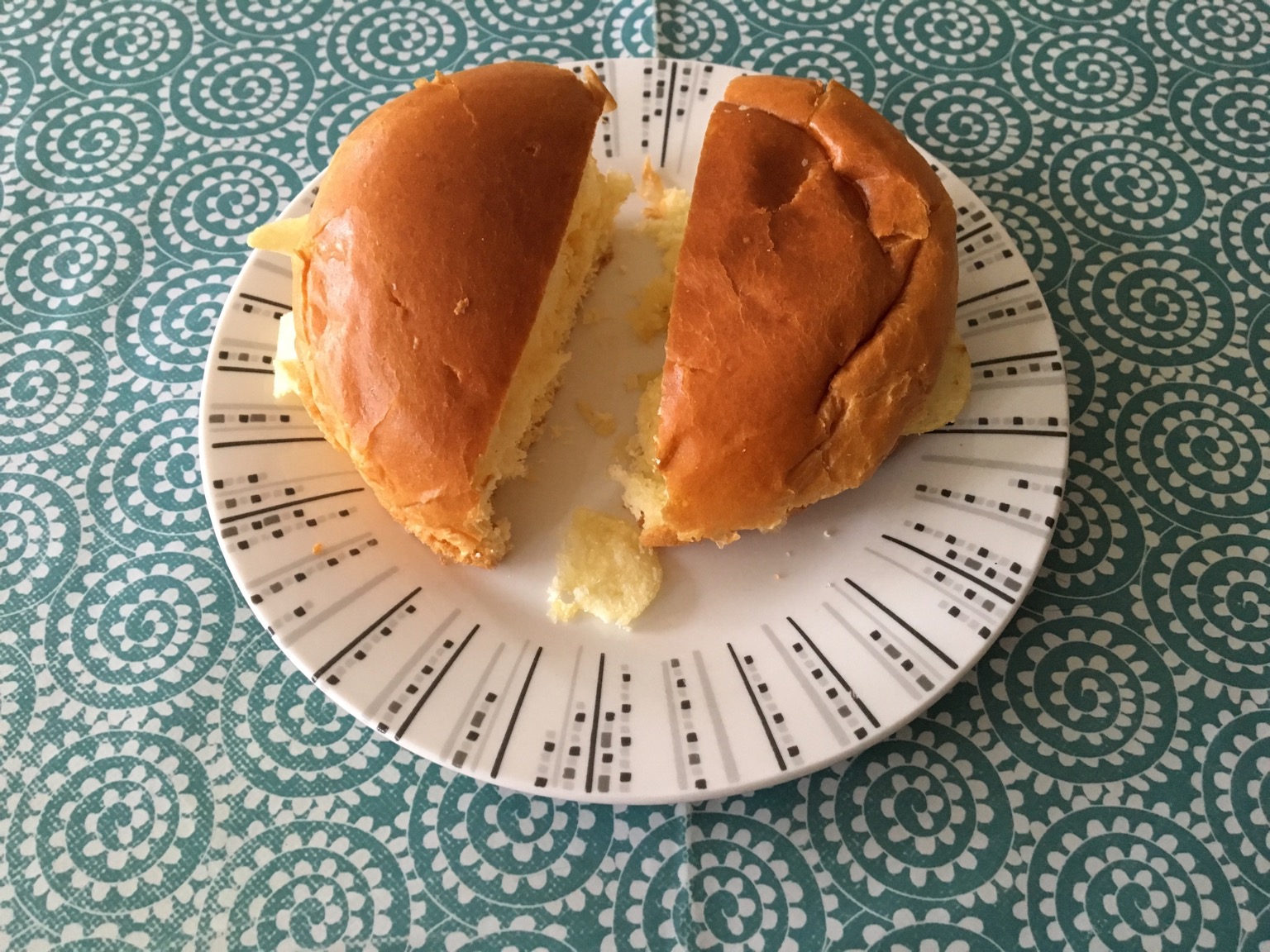 Halved brioche bun containing potato crisps