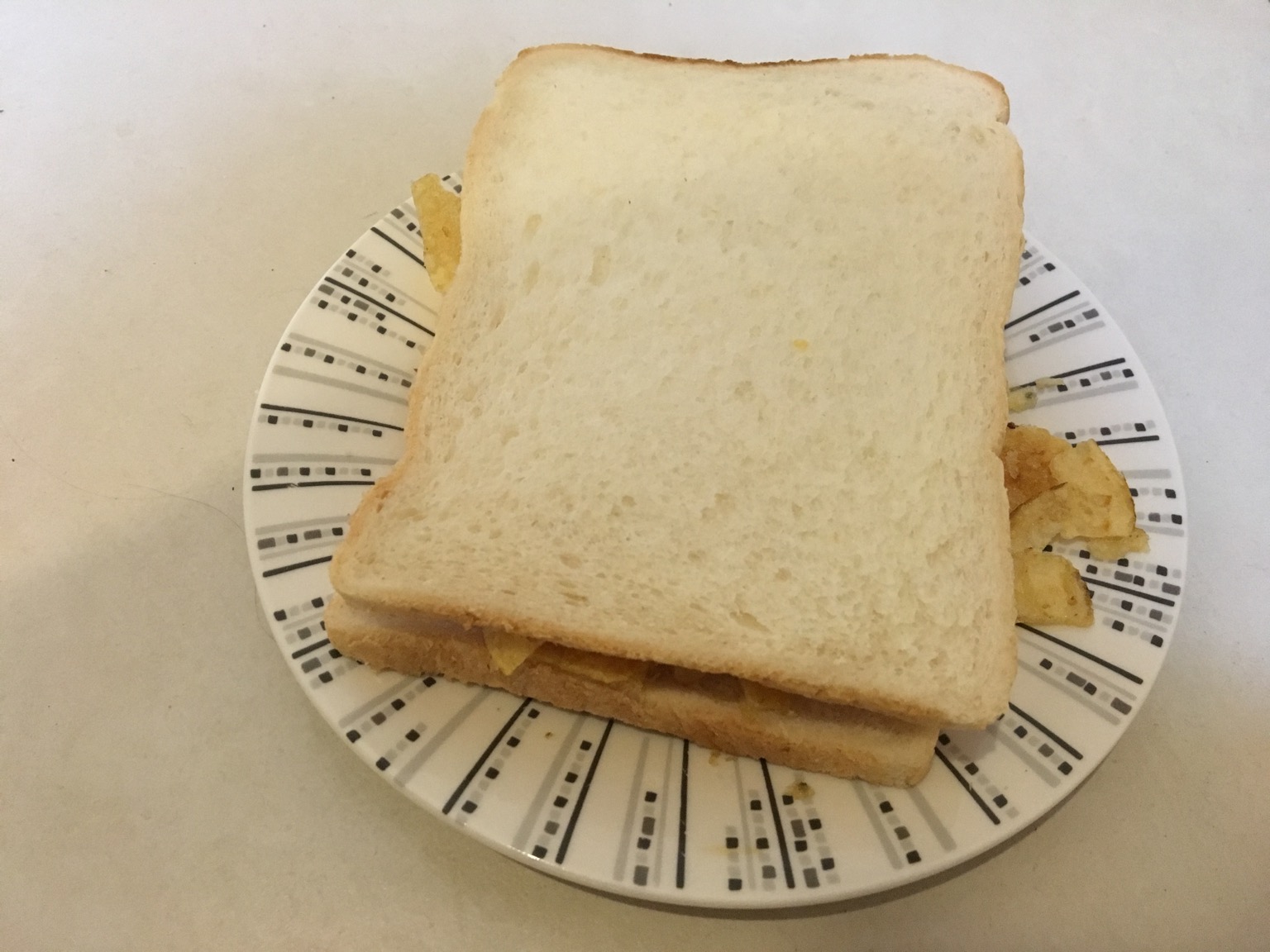 Crisps within two slices of white bread