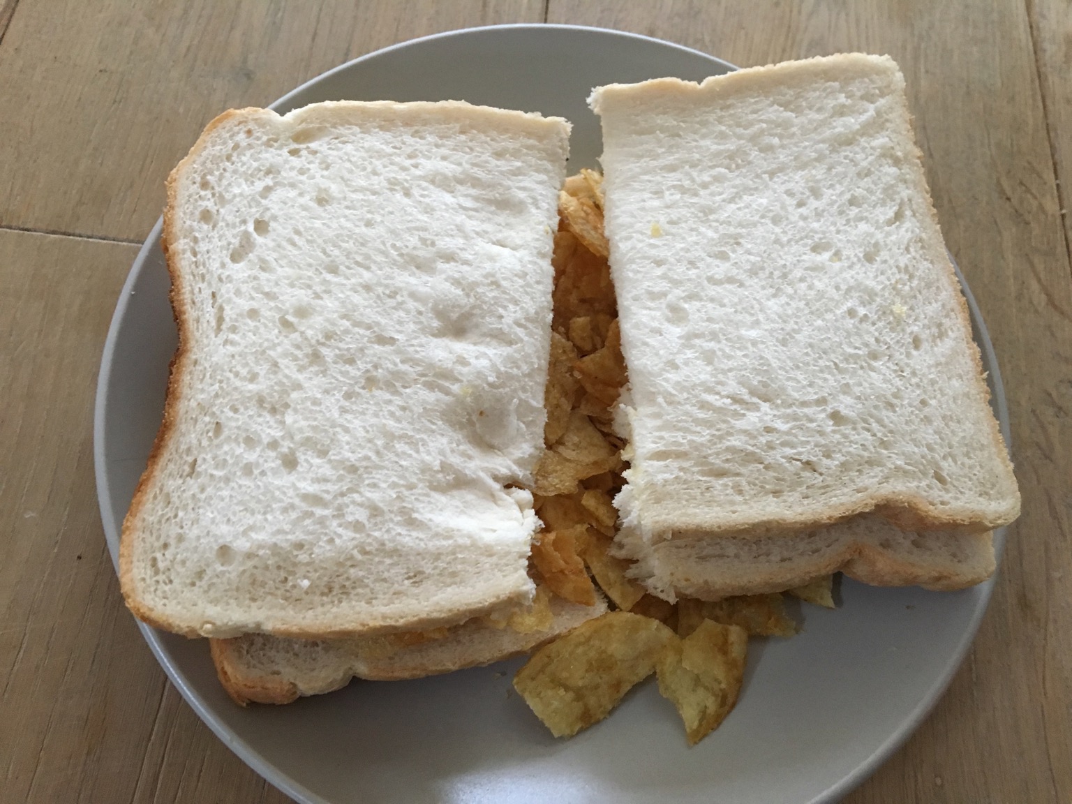 Halved crisp sandwich made with white bread