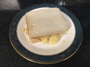 Potato crisps in white sliced bread