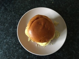 Overhead view of brioche bun containing crisps