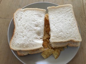 Halved crisp sandwich made with white bread