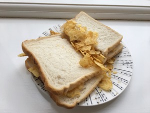 White crisp sandwich cut in half on a windowsill