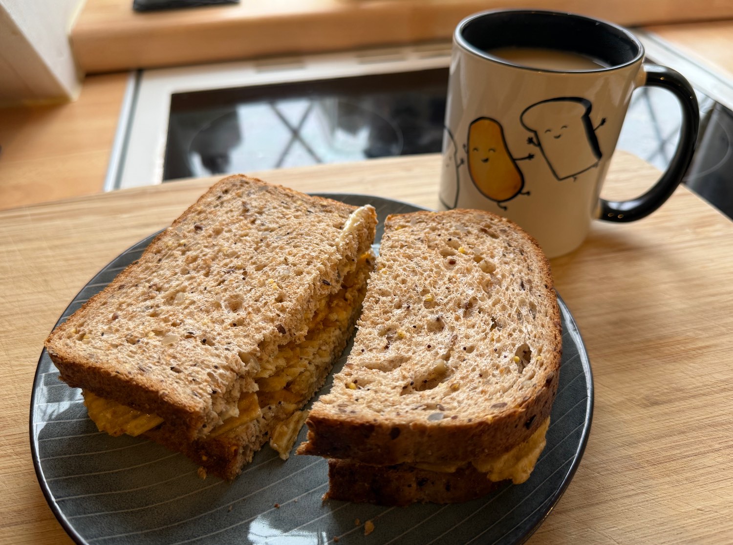 Crinkle cut cheese & onion in brown bread accompanied by a coffee in the official mug